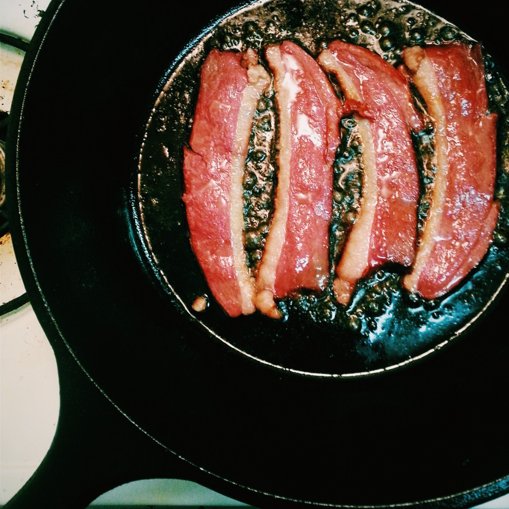 Duck bacon frying up in my trusty Lodge cast iron pan