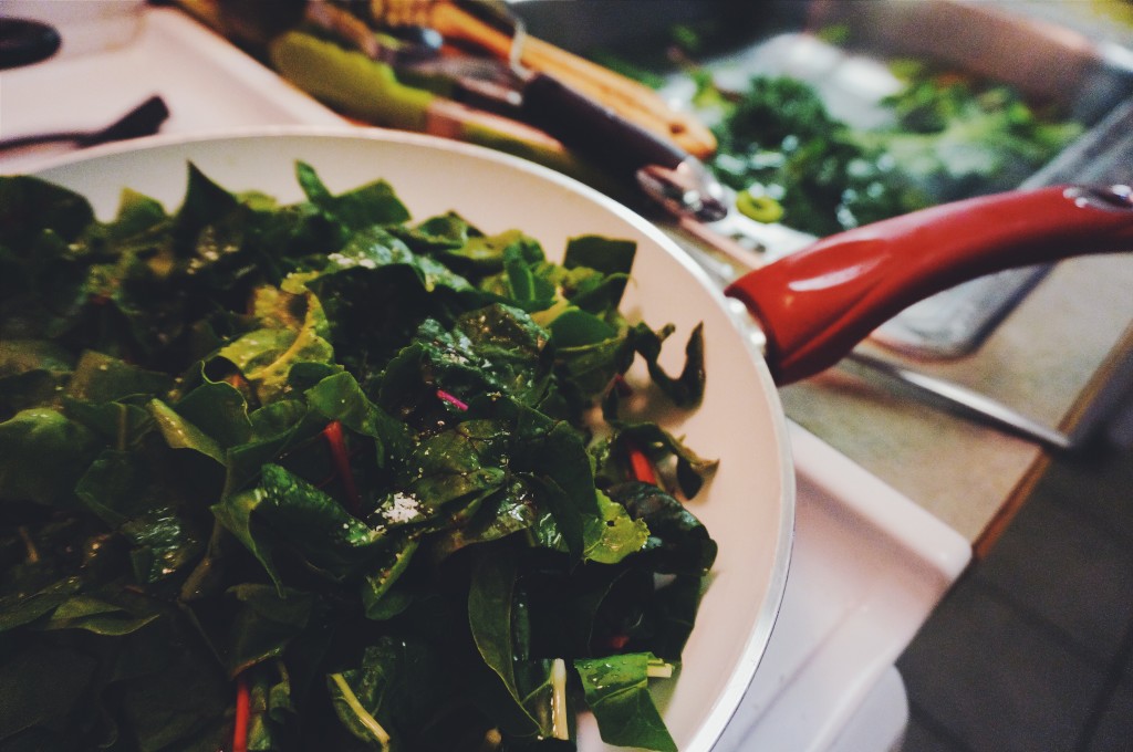 Greens in the pan and in the sink - if they won't all fit at once, layer them in as they cook down